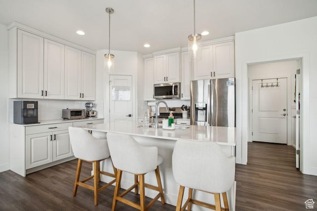 1960 W Jaydin Way S Unit 1, West Haven, UT 84401 - kitchen featuring dark wood-style flooring, white cabinets, a kitchen breakfast bar, and stainless steel appliances