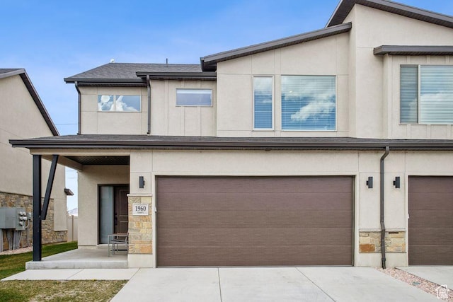 1960 W Jaydin Way S Unit 1, West Haven, UT 84401 - view of front of house featuring driveway, stucco siding, an attached garage, and stone siding