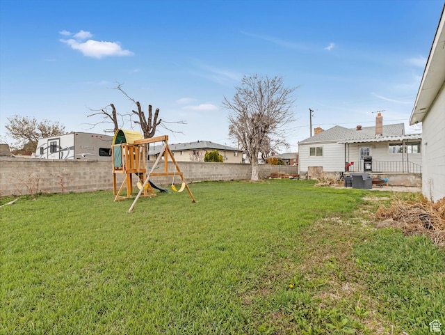 view of yard featuring a fenced backyard and a playground