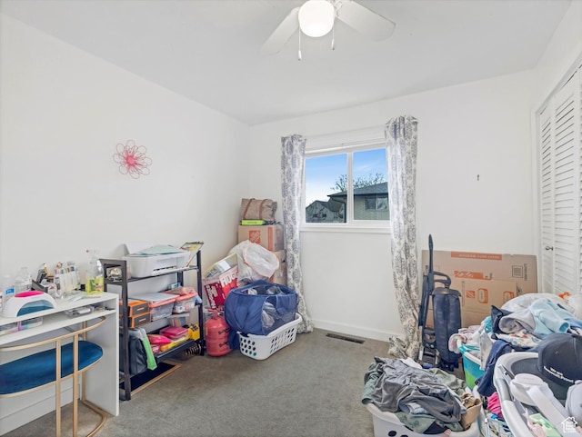 carpeted bedroom with a closet, baseboards, visible vents, and a ceiling fan