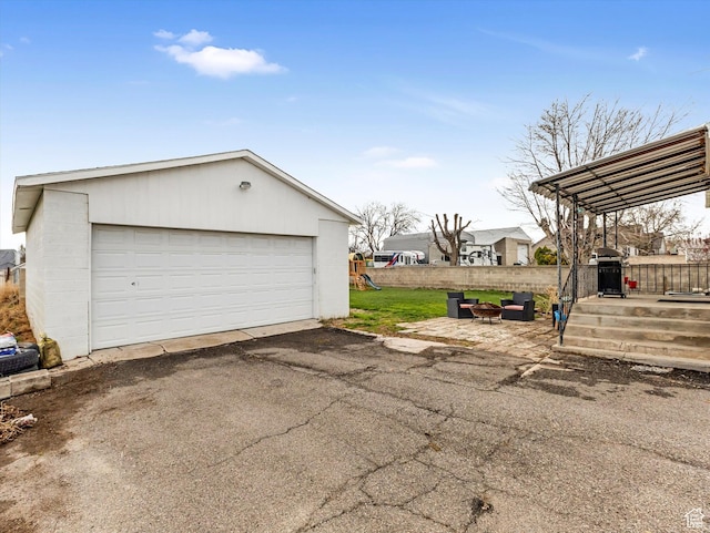 detached garage featuring fence