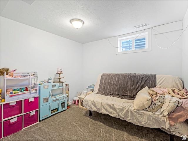 interior space with visible vents, carpet flooring, and a textured ceiling
