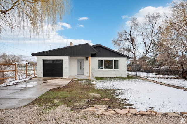 148 N Center St, Midway, UT 84049 - view of front of home with fence, an attached garage, a chimney, brick siding, and driveway