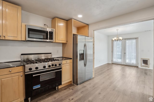 148 N Center St, Midway, UT 84049 - kitchen with an inviting chandelier, stainless steel appliances, dark countertops, light wood-style flooring, and light brown cabinets