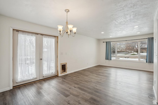 148 N Center St, Midway, UT 84049 - unfurnished room featuring baseboards, wood finished floors, french doors, and an inviting chandelier