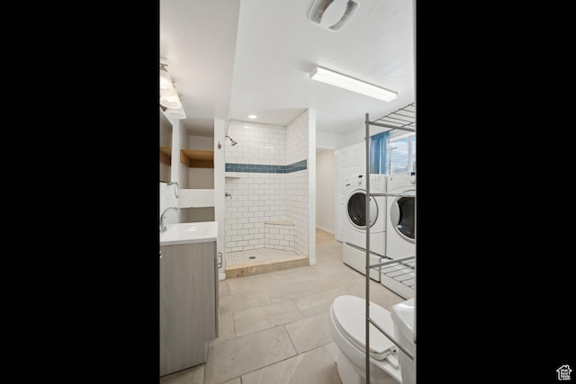148 N Center St, Midway, UT 84049 - full bathroom with a shower stall, toilet, tile patterned floors, vanity, and washing machine and dryer