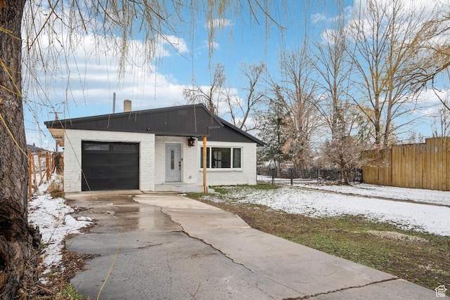 148 N Center St, Midway, UT 84049 - view of front of property featuring fence, an attached garage, a chimney, brick siding, and driveway