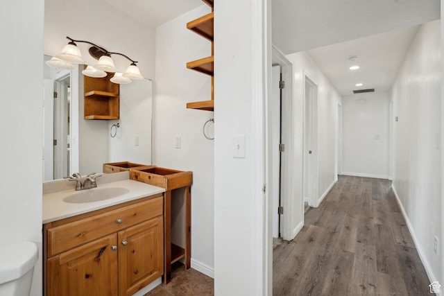 148 N Center St, Midway, UT 84049 - bathroom with vanity, recessed lighting, toilet, baseboards, and wood finished floors