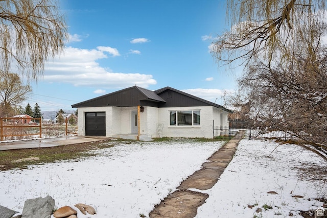 148 N Center St, Midway, UT 84049 - view of front of property featuring brick siding, concrete driveway, fence, and an attached garage