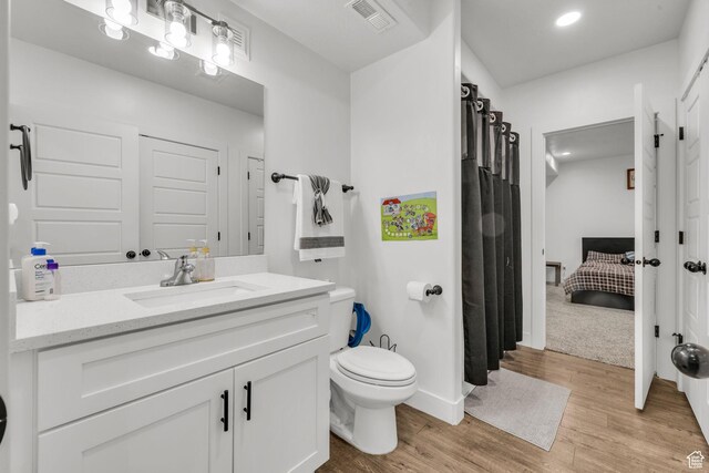 16132 S Coupler Ln Unit 406, Bluffdale, UT 84065 - bathroom featuring vanity, toilet, ensuite bath, visible vents, and wood finished floors