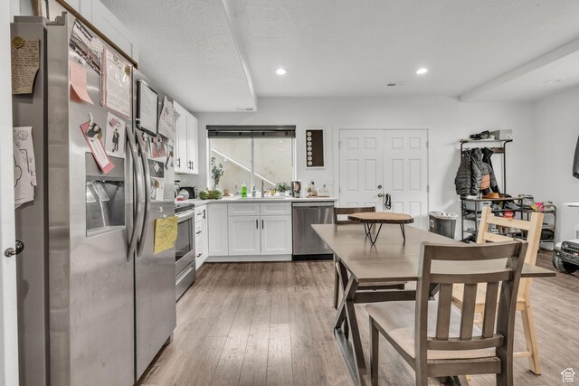 16132 S Coupler Ln Unit 406, Bluffdale, UT 84065 - kitchen with light countertops, stainless steel appliances, recessed lighting, white cabinetry, and light wood-type flooring