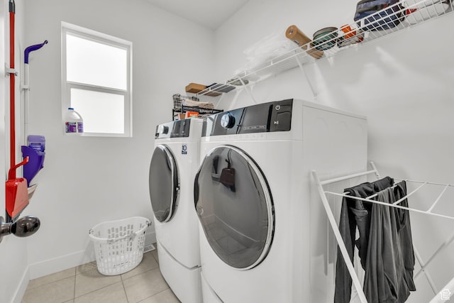 16132 S Coupler Ln Unit 406, Bluffdale, UT 84065 - clothes washing area with tile patterned flooring, baseboards, washer and dryer, and laundry area