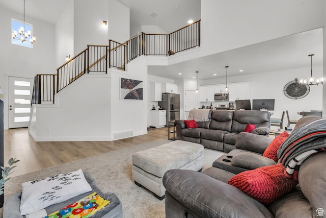 16132 S Coupler Ln Unit 406, Bluffdale, UT 84065 - living area featuring visible vents, a chandelier, baseboards, stairway, and light wood-style floors