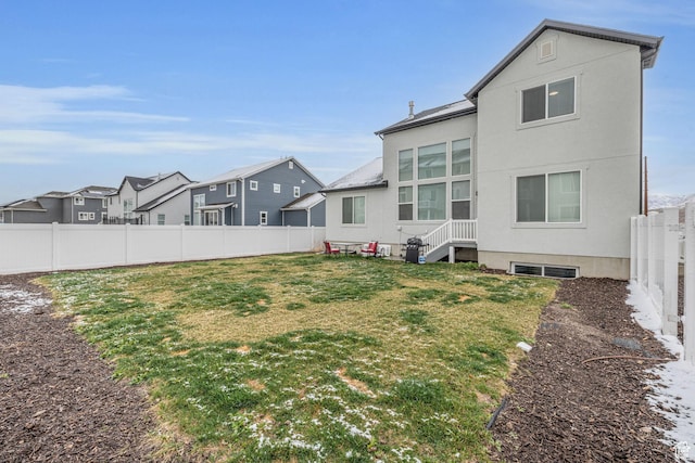 16132 S Coupler Ln Unit 406, Bluffdale, UT 84065 - back of house with stucco siding, a fenced backyard, a residential view, entry steps, and a yard