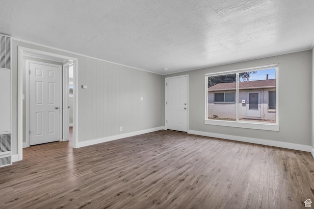2620 S 8590 W, Magna, UT 84044 - unfurnished living room featuring baseboards, wood finished floors, and a textured ceiling