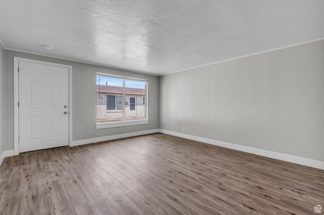 2620 S 8590 W, Magna, UT 84044 - interior space featuring ornamental molding, a textured ceiling, baseboards, and wood finished floors