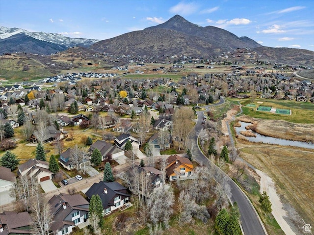 drone / aerial view featuring a residential view and a water and mountain view