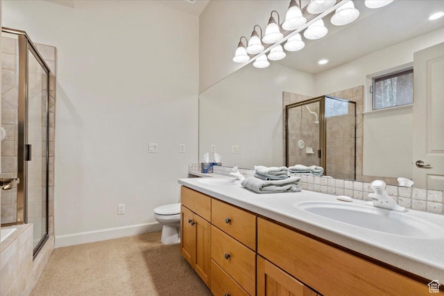 bathroom with a shower stall, double vanity, baseboards, and a sink