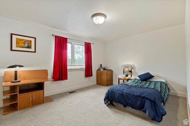 carpeted bedroom with baseboards and visible vents