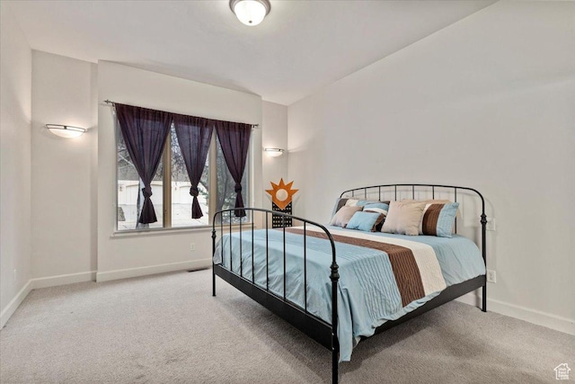 bedroom with baseboards and carpet floors