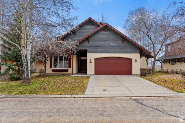 view of front of house featuring a front yard, a garage, stucco siding, and concrete driveway