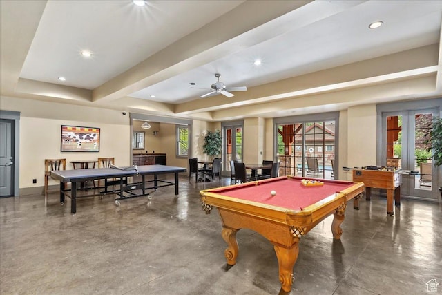 playroom featuring french doors, a raised ceiling, finished concrete floors, and a wealth of natural light