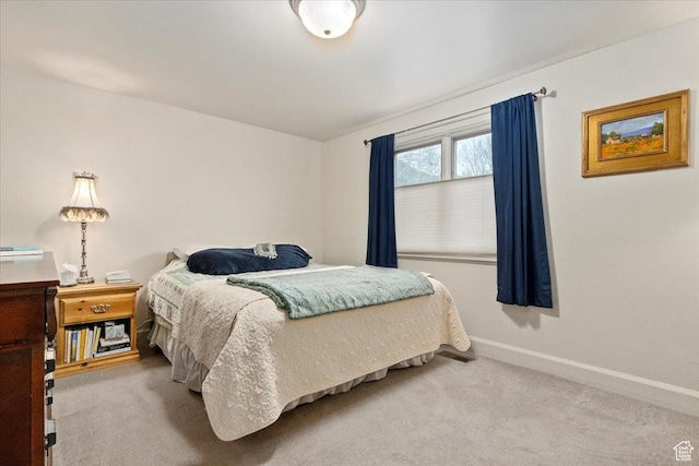 bedroom featuring baseboards and carpet