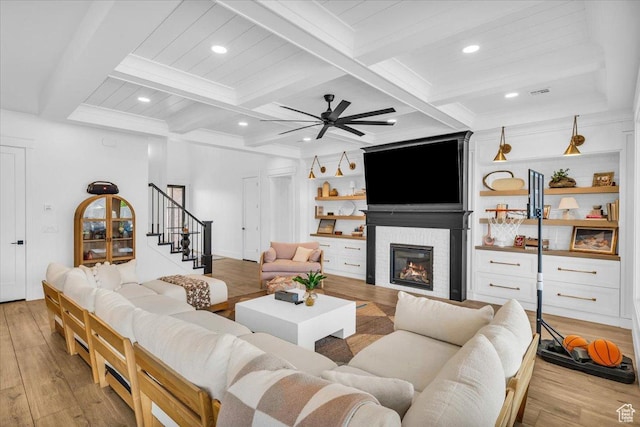 697 E Margarita Way, Washington, UT 84780 - living room featuring coffered ceiling, beam ceiling, a ceiling fan, wood finished floors, and a glass covered fireplace