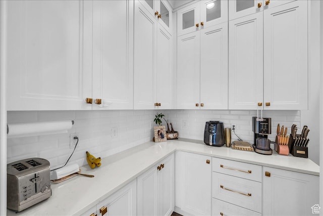 697 E Margarita Way, Washington, UT 84780 - kitchen featuring glass insert cabinets, white cabinetry, backsplash, and light countertops