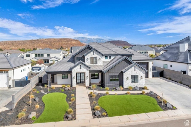 697 E Margarita Way, Washington, UT 84780 - view of front of property with board and batten siding, concrete driveway, fence, and a residential view