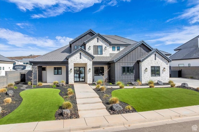 697 E Margarita Way, Washington, UT 84780 - view of front of property with stone siding, fence, a front lawn, and board and batten siding