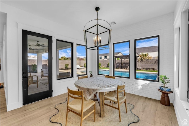 697 E Margarita Way, Washington, UT 84780 - dining room with light wood-style floors, brick wall, and a wealth of natural light