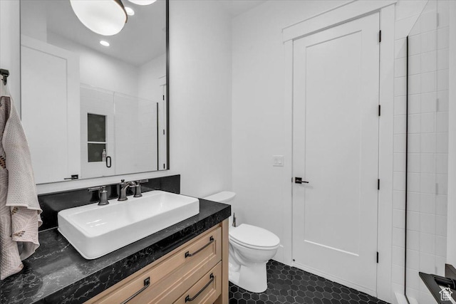 697 E Margarita Way, Washington, UT 84780 - bathroom featuring a shower with shower door, toilet, tile patterned flooring, and vanity