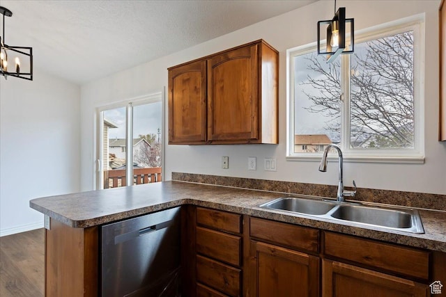 kitchen featuring a sink, dark countertops, brown cabinetry, and dishwasher
