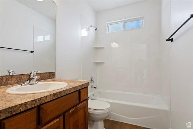 bathroom with bathtub / shower combination, toilet, and vanity