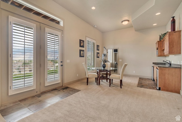 dining room featuring french doors, light carpet, baseboards, and recessed lighting
