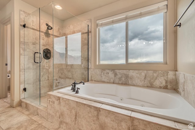 full bath with a whirlpool tub and a stall shower
