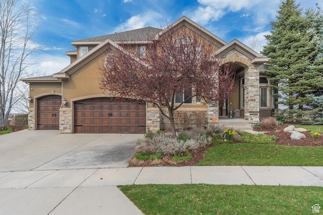 view of front facade featuring driveway, stucco siding, an attached garage, and stone siding