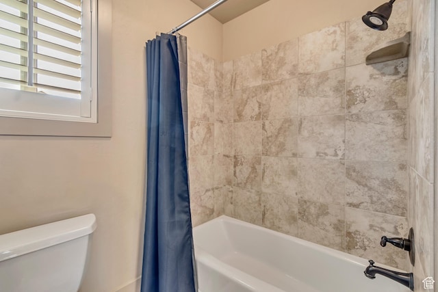 bathroom featuring toilet and shower / tub combo with curtain