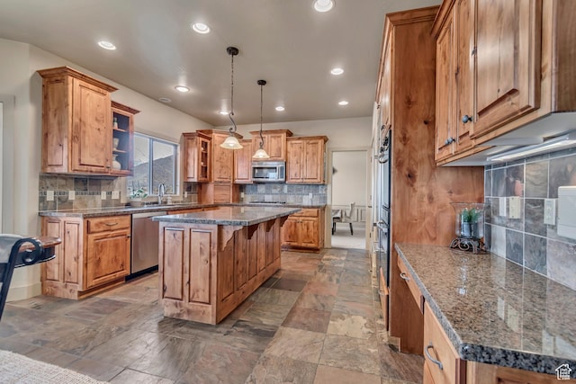 kitchen featuring recessed lighting, stainless steel appliances, a center island, and brown cabinets