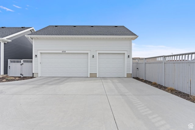 garage featuring a gate and fence