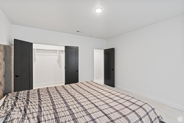 unfurnished bedroom with baseboards, carpet flooring, visible vents, and a closet