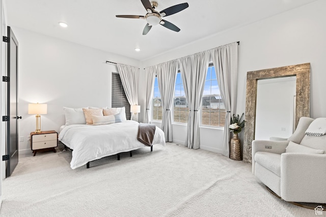 bedroom featuring baseboards, recessed lighting, a ceiling fan, and light colored carpet