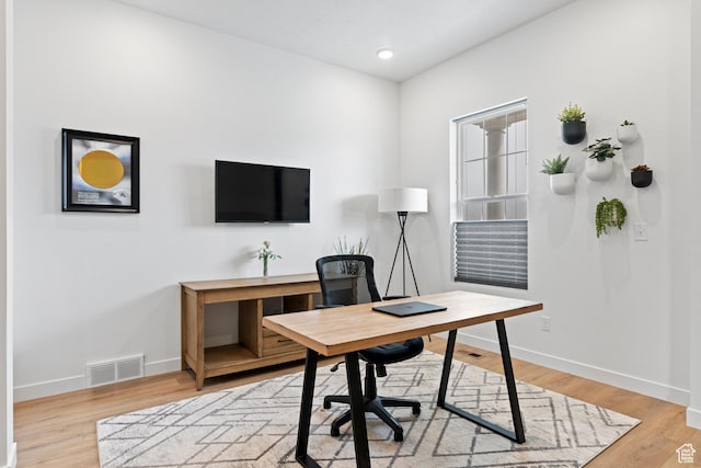 office space featuring baseboards, visible vents, light wood-style flooring, and recessed lighting