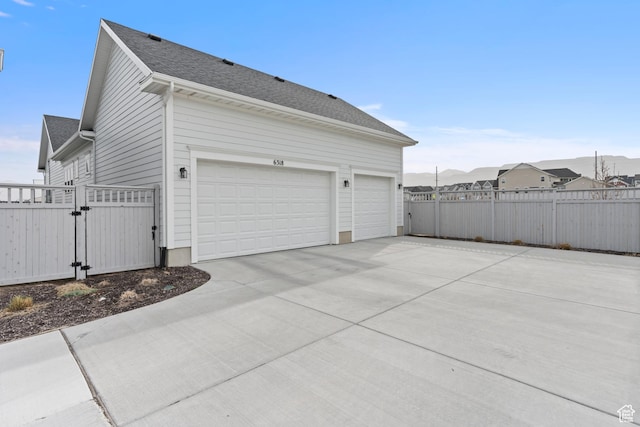 view of property exterior featuring a gate, driveway, a garage, and fence