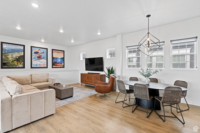 living area featuring baseboards, a wealth of natural light, light wood-style floors, and recessed lighting