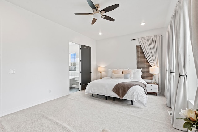 bedroom featuring connected bathroom, light carpet, baseboards, ceiling fan, and recessed lighting