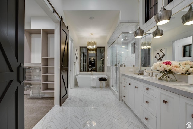 full bath with vanity, a stall shower, a soaking tub, and a notable chandelier