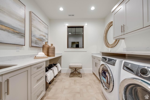 laundry room featuring recessed lighting, baseboards, visible vents, cabinet space, and washer and dryer