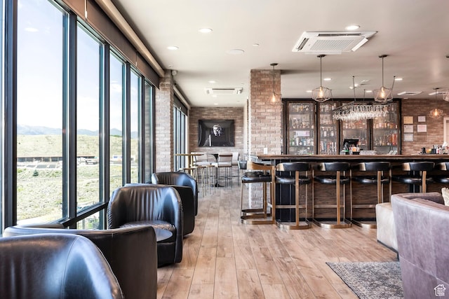 909 W Peace Tree Trl Unit 206, Kamas, UT 84036 - bar featuring brick wall, a mountain view, visible vents, a bar, and wood finished floors
